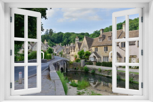 Fototapeta Naklejka Na Ścianę Okno 3D - Scenic view of traditional old cottage houses by a river in a beautiful English village - namely the landmark village of Castle Combe in Wiltshire England