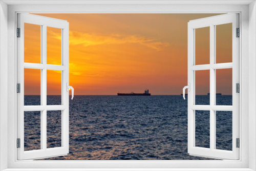 Fototapeta Naklejka Na Ścianę Okno 3D - Sea view at sunset with ships moored in the roadstead. Italy, Liguria