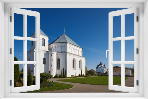 Fototapeta Naklejka Na Ścianę Okno 3D - Old ancient catholic Church of St Michael the Archangel. Orthodox church of the Transfiguration of Jesus Christ on background. Smorgon, Grodno region, Belarus.