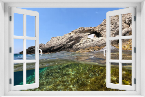 Fototapeta Naklejka Na Ścianę Okno 3D - Underwater split photo of natural exotic island rocky bay with turquoise crystal clear sea and small caves
