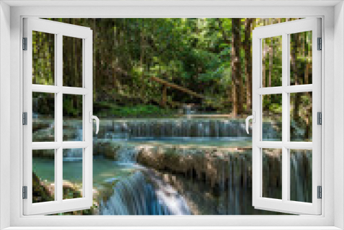 Fototapeta Naklejka Na Ścianę Okno 3D - Erawan National Park in Thailand. Erawan Waterfall is a popular tourist destination and famous for its emerald blue water. Deep forest in tropical climate with fantasy atmosphere.	
