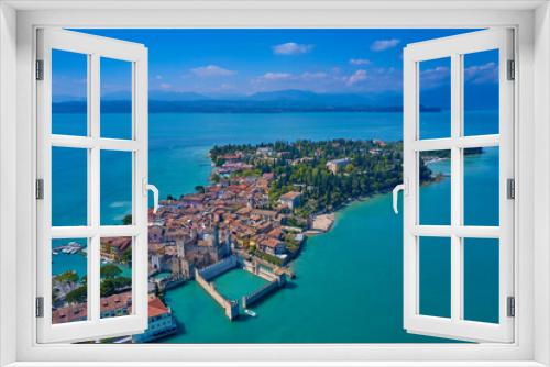 Fototapeta Naklejka Na Ścianę Okno 3D - Aerial photography with drone, Rocca Scaligera Castle in Sirmione. Garda, Italy. Aerial view of Sirmione. Sirmione Castle, Lake Garda, Italy. The flag of Italy on the main tower of the castle. 