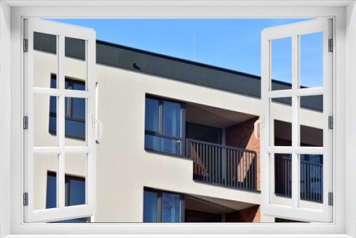 Fototapeta Naklejka Na Ścianę Okno 3D - Abstract architecture, fragment of modern urban geometry,. Modern apartment building on a sunny day with a blue sky,. European residential apartment buildings.