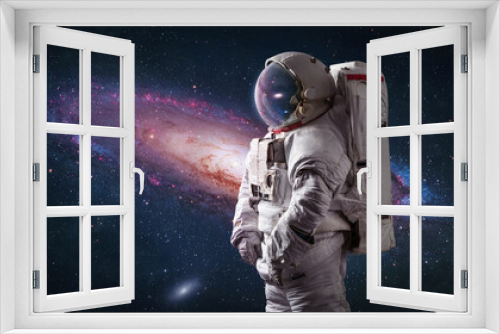 Fototapeta Naklejka Na Ścianę Okno 3D - Astronaut in bright space with galaxy Andromeda. Spaceman with starry and galactic background. Sci-fi wallpaper. Elements of this image furnished by NASA