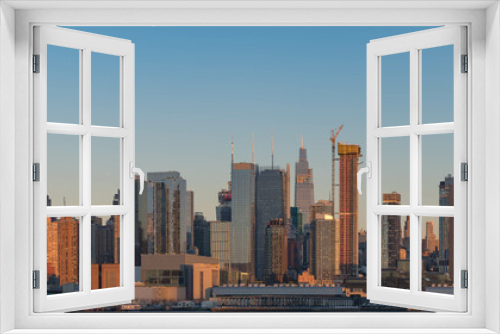 Fototapeta Naklejka Na Ścianę Okno 3D - Manhattan skyline panoramic view, perfect for web design banner, during clear sky day right before sunset.