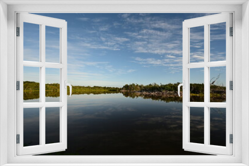 Fototapeta Naklejka Na Ścianę Okno 3D - Morning clouds over Eco Pond in Everglades National Park, Florida reflected in pond's tranquil water.