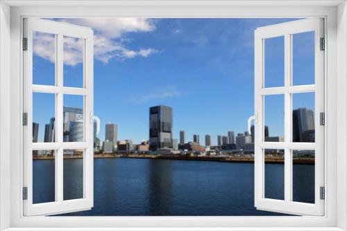 Fototapeta Naklejka Na Ścianę Okno 3D - 青空と水辺にあるビル群　青い空の東京