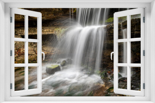 Fototapeta Naklejka Na Ścianę Okno 3D - Oglebay Falls, a beautiful cascading waterfall within Oglebay Park in Wheeling, West Virginia, in seen splashing onto and over a rocky ledge.