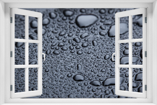 Fototapeta Naklejka Na Ścianę Okno 3D - Drops of rain on a black rubber surface close-up.