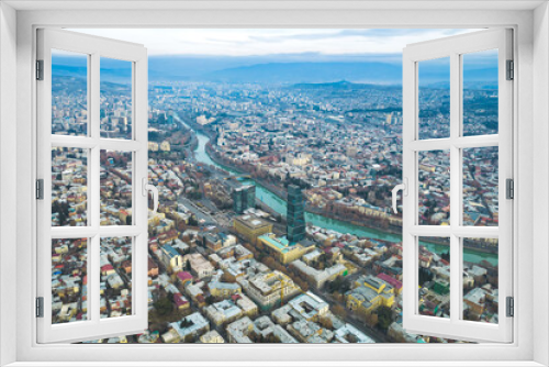 Fototapeta Naklejka Na Ścianę Okno 3D - Aerial view of Tbilisi city center with churches and modern buildings and emerald waters of Kura river