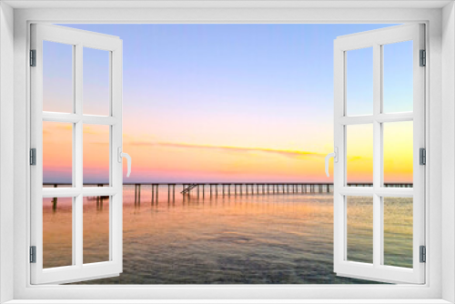 Fototapeta Naklejka Na Ścianę Okno 3D - Old wooden pier against the backdrop of the sea and a beautiful sunset.
