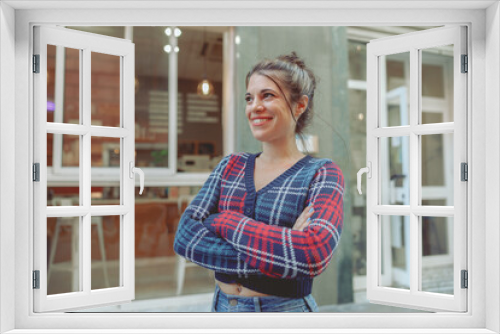 Happy lady in cropped cardigan standing near cafe