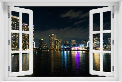Fototapeta Naklejka Na Ścianę Okno 3D - Night view of a high-rise condominium along an urban river_r_19