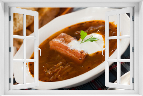 Fototapeta Naklejka Na Ścianę Okno 3D - Thick Russian-style cabbage soup (Shchi) with pork cooked in mushroom broth served with sour cream