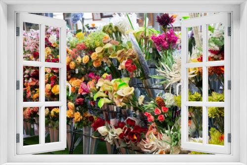 Fototapeta Naklejka Na Ścianę Okno 3D - Colorful showcase of flower shop with large assortment of artificial flowers