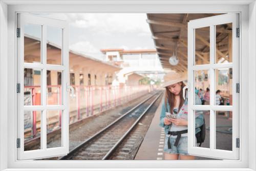 Asian tourist wait train at train station,thailand hipster womanman go to travel,Have a camera in hand