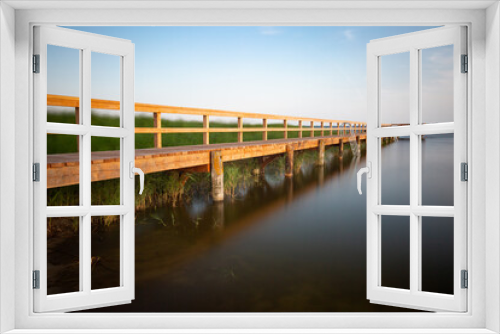 Fototapeta Naklejka Na Ścianę Okno 3D - Wooden jetty and reed grass - long exposure