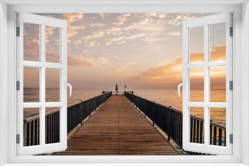 Fototapeta Naklejka Na Ścianę Okno 3D - Beautiful sunrise over the ocean with a footbridge in Makadi Bay, Egypt