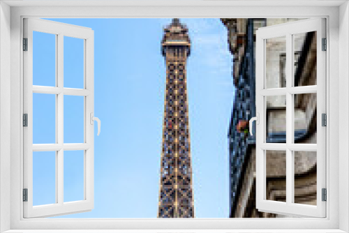 Fototapeta Naklejka Na Ścianę Okno 3D - Eiffel Tower looking through buildings in Paris, France