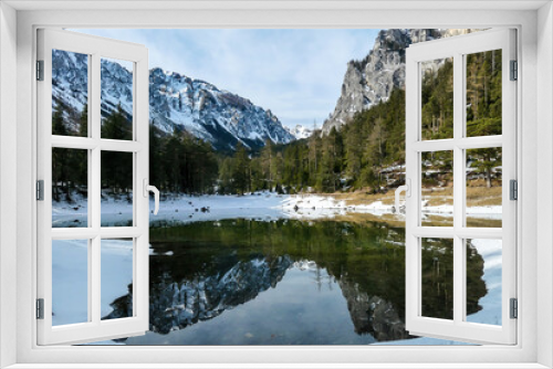 Fototapeta Naklejka Na Ścianę Okno 3D - Winter landscape of Austrian Alps with Green Lake in the middle. Powder snow covering the mountains and ground. Soft reflections of Alps in calm lake's water. Winter wonderland. Serenity and calmness