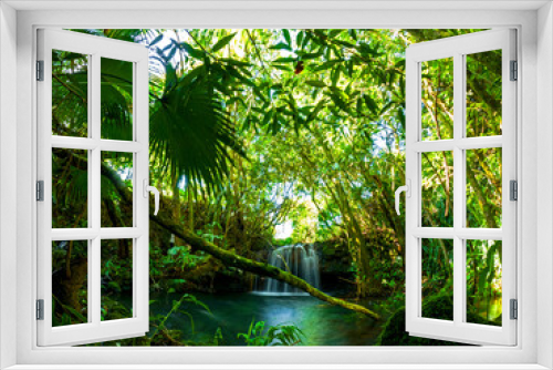 Fototapeta Naklejka Na Ścianę Okno 3D - Long exposure view of a waterfall hidden in a dark forest located in Mauritius	