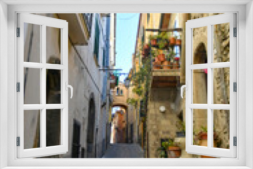 Fototapeta Naklejka Na Ścianę Okno 3D - A narrow street among the old stone houses of Altavilla Silentina, town in Salerno province, Italy.	