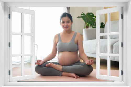 Young pregnant woman doing yoga at home, healthcare and pregnancy care concept