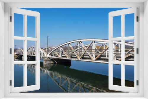 Fototapeta Naklejka Na Ścianę Okno 3D - Steel bridge over the water, over Jiu. Ferdinand Bridge in Targu Jiu.