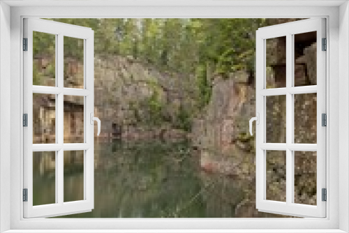 Fototapeta Naklejka Na Ścianę Okno 3D - Old rock quarry filled with water in summer at Vehmaa, Finland.