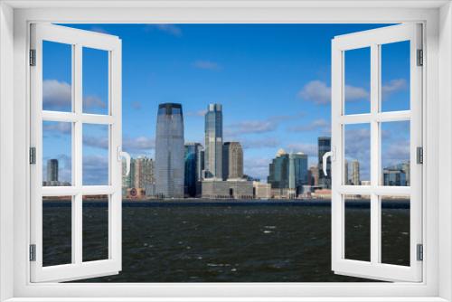 Fototapeta Naklejka Na Ścianę Okno 3D - Views of Battery Park and the financial district from the water and Ellis Island in New York City