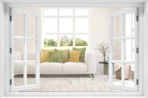 White living room with sofa and summer landscape in window. Scandinavian interior design. 3D illustration