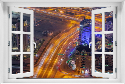 Fototapeta Naklejka Na Ścianę Okno 3D - Bussy traffic on the overpass intersection in Dubai downtown aerial night timelapse.