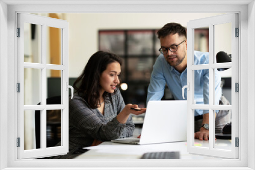 Colleagues in office. Businesswoman and businessman discussing work in office.