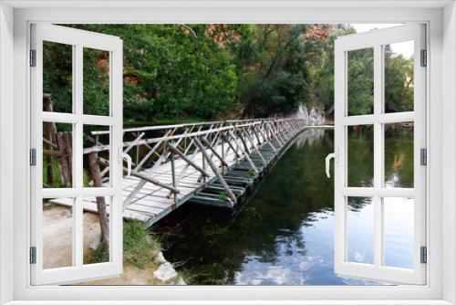 Fototapeta Naklejka Na Ścianę Okno 3D - on a quiet lake floating wooden bridge