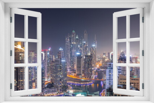 Fototapeta Naklejka Na Ścianę Okno 3D - View of various skyscrapers in tallest recidential block in Dubai Marina aerial all night timelapse