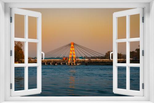 Fototapeta Naklejka Na Ścianę Okno 3D - isolated cable bridge over ganges river with colorful sky at evening