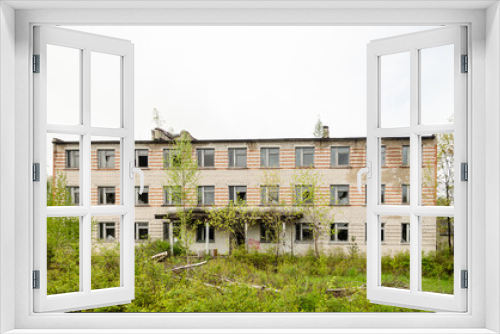 Fototapeta Naklejka Na Ścianę Okno 3D - Abandoned white brick multistorey houses. Forgotten, abandoned ghost town Skrunda, Latvia. Former Soviet army radar station.