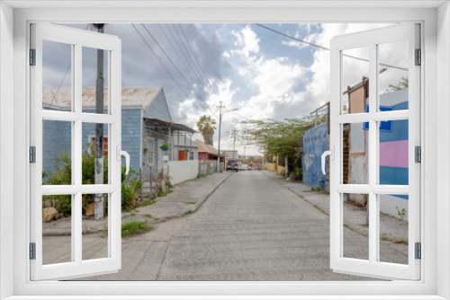 Fototapeta Naklejka Na Ścianę Okno 3D - House with light blue wooden facade and white framing in the suburbs of Willemstad, Curacao