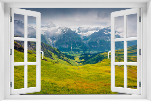 Fototapeta Naklejka Na Ścianę Okno 3D - Wonderful summer view from the top of Grindelwald First cableway. Schreckhorn summit in the morning mist, Grindelwald village location, Swiss Bernese Alps, Switzerland, Europe.