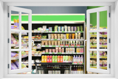 choosing a dairy products at supermarket.empty grocery cart in an empty supermarket