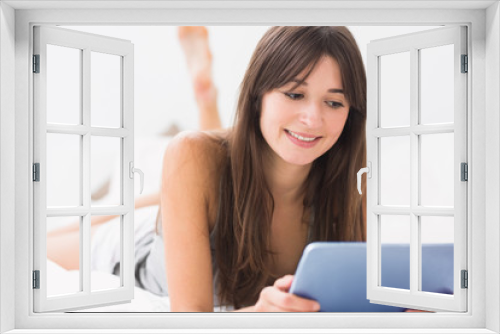 Smiling woman using digital tablet