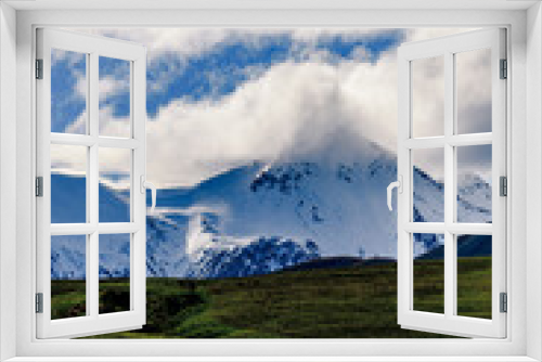 Snow covered peaks in mountain landscape