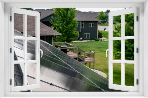 Fototapeta Naklejka Na Ścianę Okno 3D - Selective focus on solar panels installed on a residential asphalt shingle roof