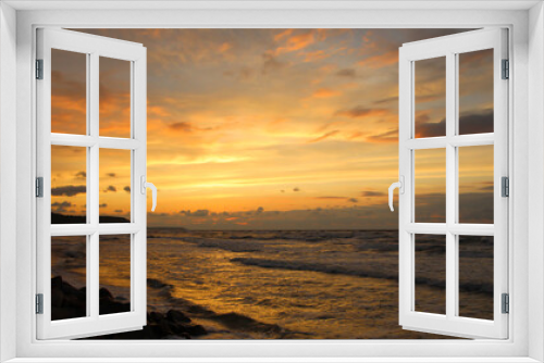 Fototapeta Naklejka Na Ścianę Okno 3D - Beautiful sunset over the sea with orange reflexes on clouds and sea foam