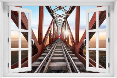 Fototapeta Naklejka Na Ścianę Okno 3D - Red Railway Bridge against beautiful sunset view.