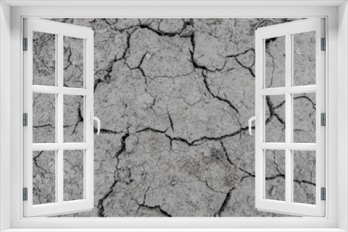 Fototapeta Naklejka Na Ścianę Okno 3D - A fragment of the muddy surface of the earth cracked by drought