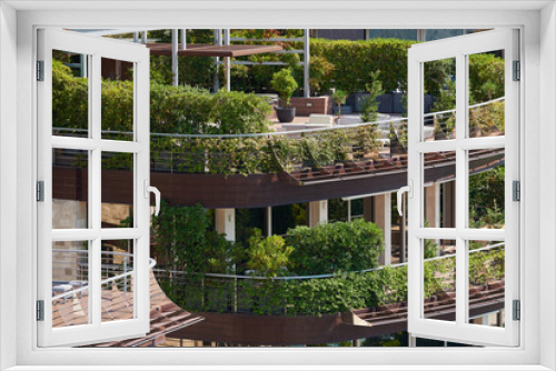 Fototapeta Naklejka Na Ścianę Okno 3D - Terrace of a building decorated with plants in a European city