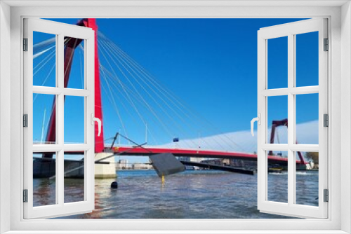 Fototapeta Naklejka Na Ścianę Okno 3D - Bright red Willemsbrug bridge over the river Meuse with blue sky