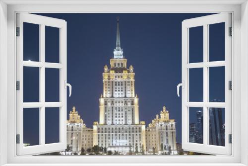 Fototapeta Naklejka Na Ścianę Okno 3D - Large building with tower glows at night. Action. Beautiful large MSU building at night. Moscow University building glows at night