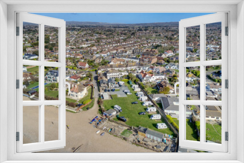 Fototapeta Naklejka Na Ścianę Okno 3D - East Preston village Seafront and beach in West Sussex on the south coast of England with the South Downs in the background, Aerial photo.